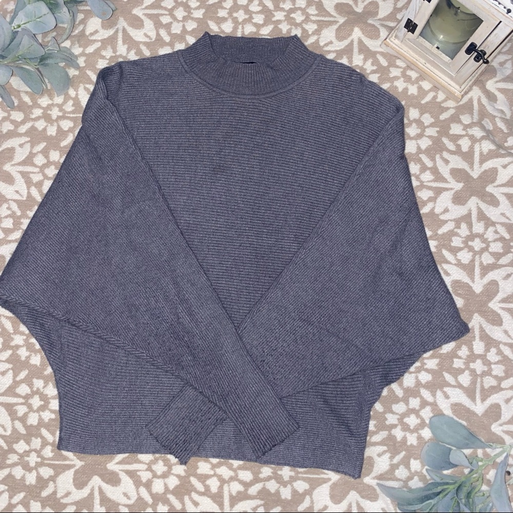 Grey long sleeve top.